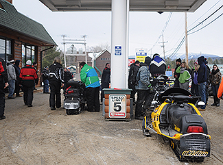 Snowmobilers gas up their sleds